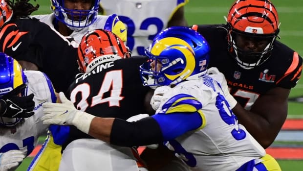 Feb 13, 2022; Inglewood, California, USA; Cincinnati Bengals halfback Samaje Perine (34) runs with the ball against Los Angeles Rams defensive end Aaron Donald (99) in the fourth quarter of Super Bowl LVI at SoFi Stadium. Mandatory Credit: Gary A. Vasquez-USA TODAY Sports